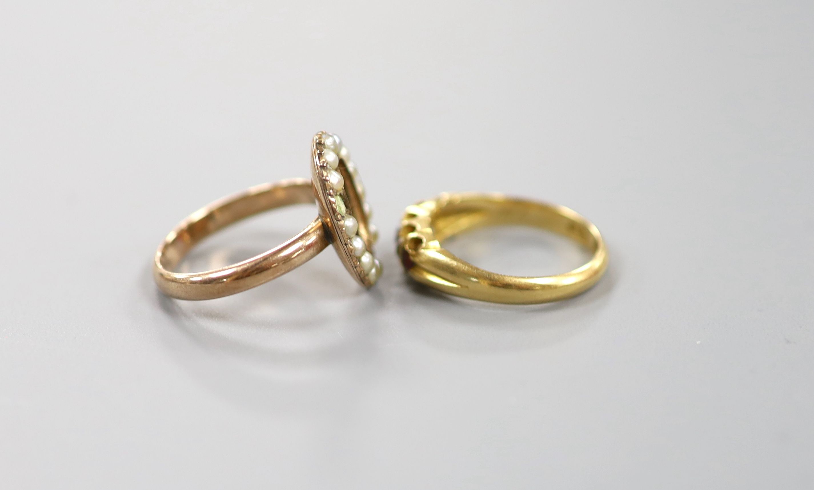 A Victorian 15ct gold, ruby and diamond set half hoop ring (stone missing), size M, gross 3.5 grams and a 19th century yellow metal and seed pearl set mourning ring, with plaited hair (glazed panel missing & two pearls m